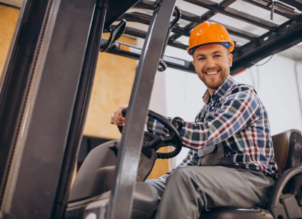man-working-warehouse-driving-forklift